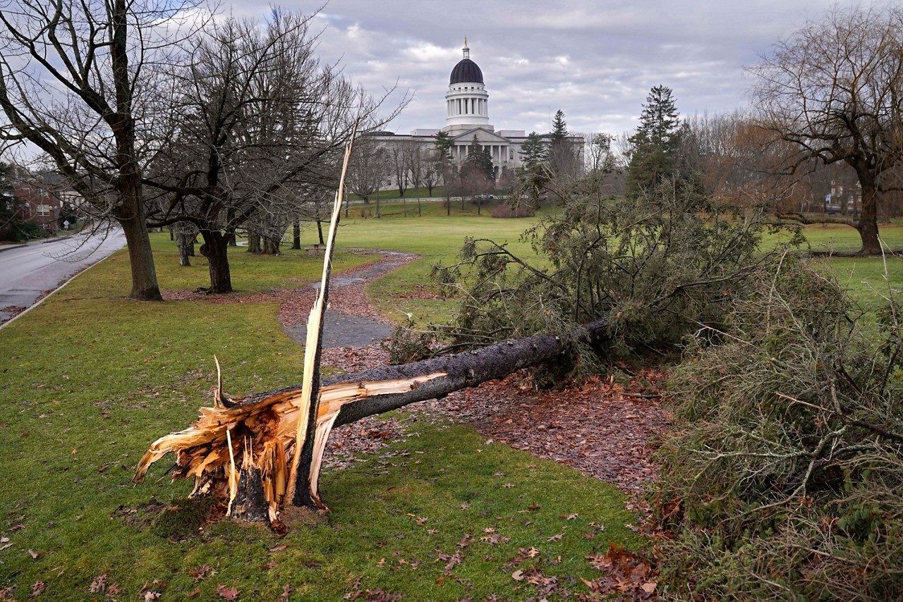 Trees lay broken in a park across the the State House, Tuesday, Dec. 19. Thousands remain without electricity following Monday's severe storm. (AP Photo/Robert F. Bukaty)